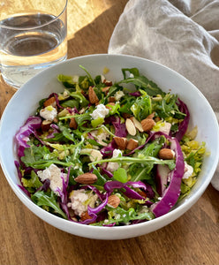 Hearty Winter Greens Salad with Pomegranate Seeds + Toasted Almonds by Lisa Malin. Try out this hearty, fiber-fueled salad recipe!